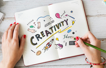 Wall Mural - young woman drawing creativity in a notebook