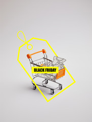 close up view of shopping cart with little goods made of paper on grey background, black friday sale tag