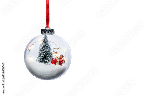 Clear Ball Ornament  with christmas tree,  small gift and christmas light inside.  Clear Ball Ornament  with Christmas decorations isolated on white background.