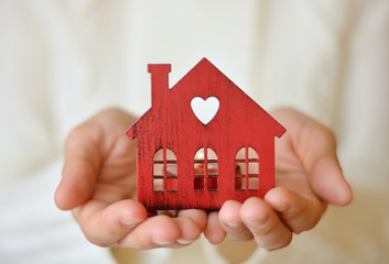 warm and cozy miniature house in female hands. care and love.