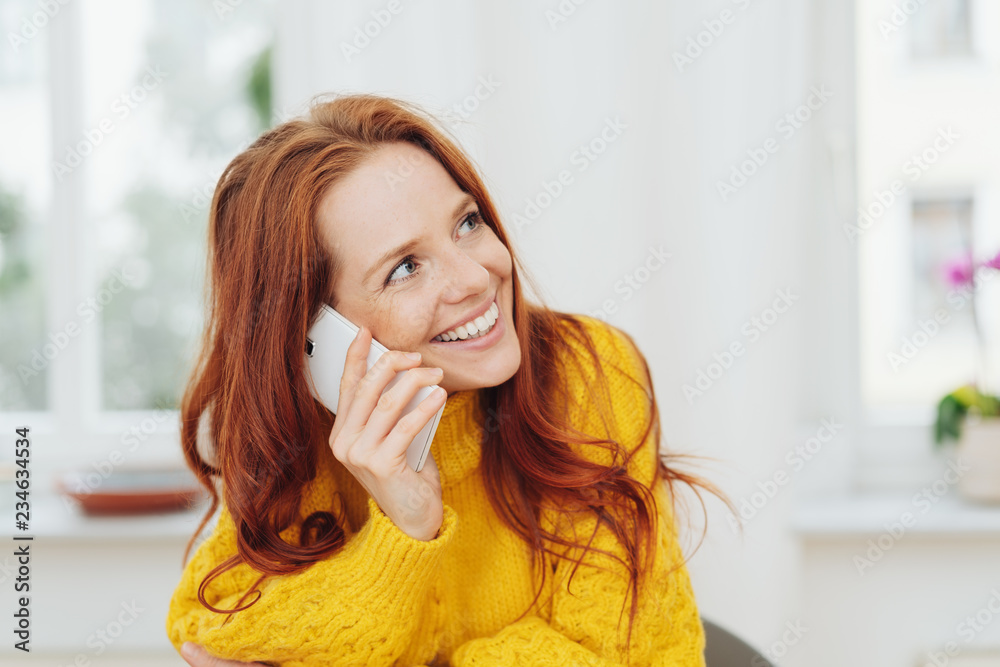 Cheerful red-haired woman talking on phone - obrazy, fototapety, plakaty 