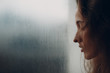© primipil - Portrait of young beautiful woman profile near misted autumn rainy window bad weather
