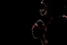 American Football Player Standing With Rugby Helmet And Ball