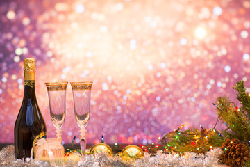 New years eve celebration background with champagne and a pair of glasses with christmas decoration. Party and celebration concept.