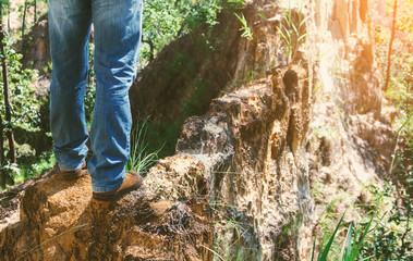 close-up hiking boots. male tourist steps on a trail in forest