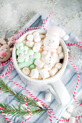 Wall Mural - Creative idea for christmas drink, delicious hot chocolate with funny marshmallow snowman, christmas tree, rain dear, santa, on home background with xmas decoration copy space top view