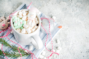 Wall Mural - Creative idea for christmas drink, delicious hot chocolate with funny marshmallow snowman, christmas tree, rain dear, santa, on home background with xmas decoration copy space top view