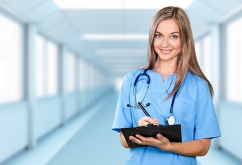 Wall Mural - Attractive young female doctor student on background