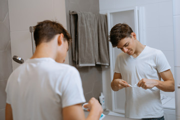 putting tooth paste on tooth brush.