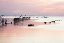 Silhouette Of Square Dip Nets With Sunrise Sky Background, Livelihoods Of Fishermen At Pakpra, Phattalung In Thailand