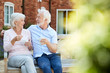 © Monkey Business - Retired Couple Sitting On Bench With Hot Drink In Assisted Living Facility