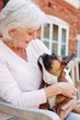 © Monkey Business - Senior Woman Sitting On Bench With Pet French Bulldog In Assisted Living Facility