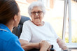 © Monkey Business - Senior Woman Sitting In Motorized Wheelchair Talking With Nurse In Retirement Home