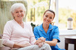 © Monkey Business - Portrait Of Senior Woman Sitting In Chair With Nurse In Retirement Home