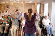 © Monkey Business - Carer Leading Group Of Seniors In Fitness Class In Retirement Home