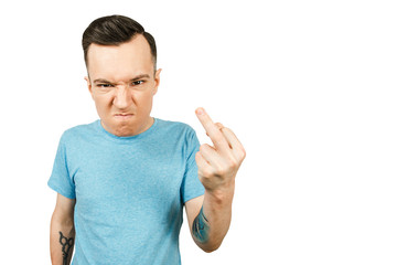 Portrait of young sullen guy showing middle finger isolated on a white background.