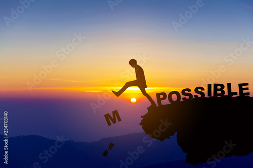 Fotografía Silhouette man pushing letters I and M from the rock