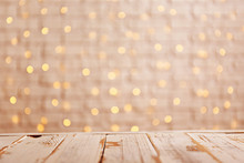 Selective Focus. Soft Yellow Christmas Lights With Bokeh Effect. Festive Blurry Texture Background With Many Lit Mini Lamps, New Year Holiday Decorations. Close Up, Copy Space.
