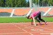 © Oleg Shapoval - A young girl in the stadium is preparing to start.