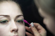 © strigana - Eye lash extension procedure. Young beautiful woman eye with long false green eye lashes. Close up macro shot of fashion eyes in beauty salon.