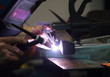 worker tig welding metal