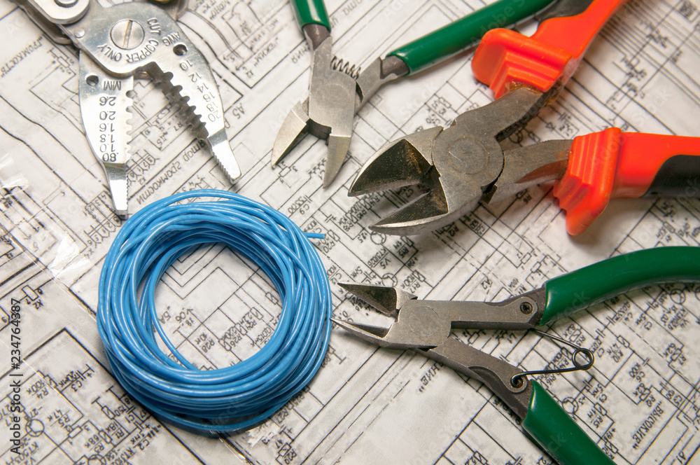 Cut wire cutters to strip ends of electrical wires. Tools for ...