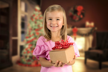 warm photo of girl giving getting small christmas gift present kid toddler tree background 