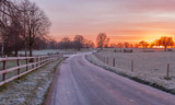 Fototapeta Tęcza - country road at sunrise at Riseholme lincolnshire
