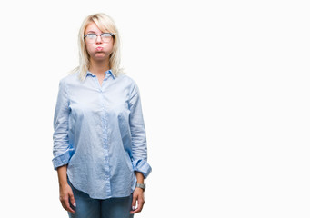 Poster - Young beautiful blonde business woman wearing glasses over isolated background puffing cheeks with funny face. Mouth inflated with air, crazy expression.