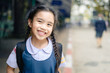 © escapejaja - back to school. Happy smiling girl from elementary school at the school yard.
