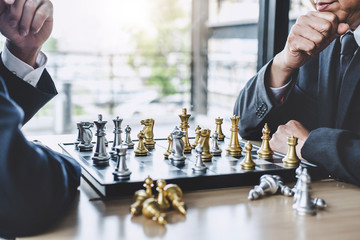 Wall Mural - Two businessman playing chess game to plan strategy for success, thinking for planning overcoming difficulty and achieving goals business strategy for win