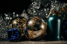Gold Christmas Ball And Blue Ring With Small Gift And Black Background