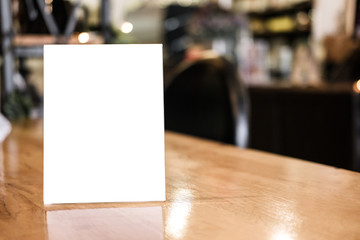 Wall Mural - Mock up blank menu frame on table in coffee shop stand for your text of display your product