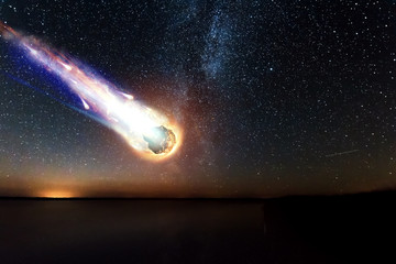 a comet, an asteroid, a meteorite falls to the ground against a starry sky. attack of the meteorite.