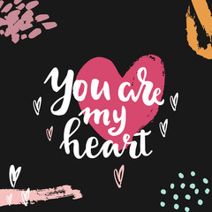 Wall Mural - Hand written lettering quote about love and relationship. Hand drawn lettering words you are my heart.Valentine day card on black background with colorful paint splashes