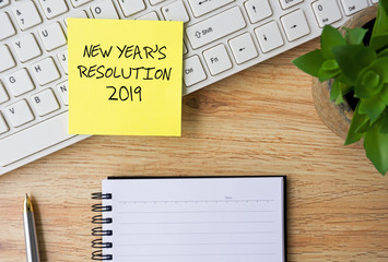 Wall Mural - New Year Resolutions 2019 written on sticky note on Top Of Office desk