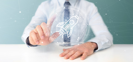 Poster - businessman holding a start up rocket on a sphere 3d rendering