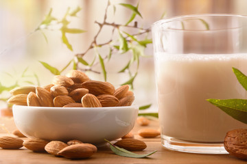 Wall Mural - Almond drink and container with fruits on table front view