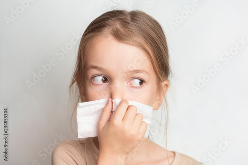 Fotografie, Obraz Runny nose in children. A child blows his nose in a handkerchief