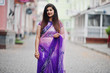 © AS Photo Family - Indian hindu girl at traditional violet saree posed at street.