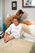 © David Pereiras - Female caregiver accommodating the pillow to elderly female patient