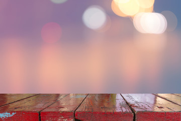 Canvas Print - wooden desk with blurred light bokeh abstract background