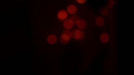 Sticker - Christmas holiday blurred fireworks, abstract motion background, bokeh. Defocused falling circle lights on black backdrop. 4K UHD video footage. Slow motion 3840X2160