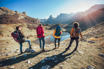 Wall Mural - Group of hikers walking on a mountain at autumn day