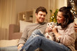 © Syda Productions - pets, hygge and people concept - happy couple with cat at home