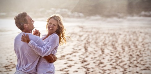 Mature couple having fun together at beach