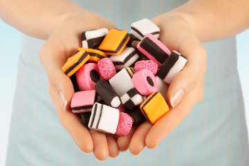 Wall Mural - WOMAN HOLDING LICORICE ALLSORTS SWEETS / CANDIES