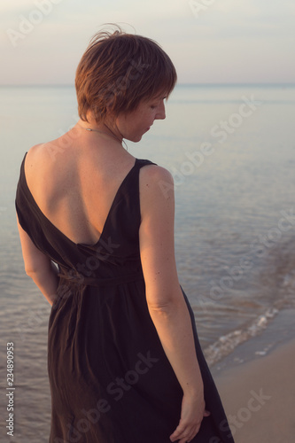 Portrait Of A Woman In A Black Dress With A Short Haircut From The