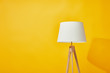 Minimalistic lamp on bright yellow background
