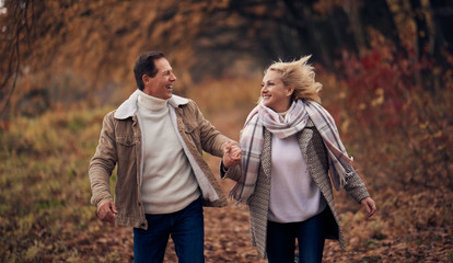 Senior couple in park in autumn